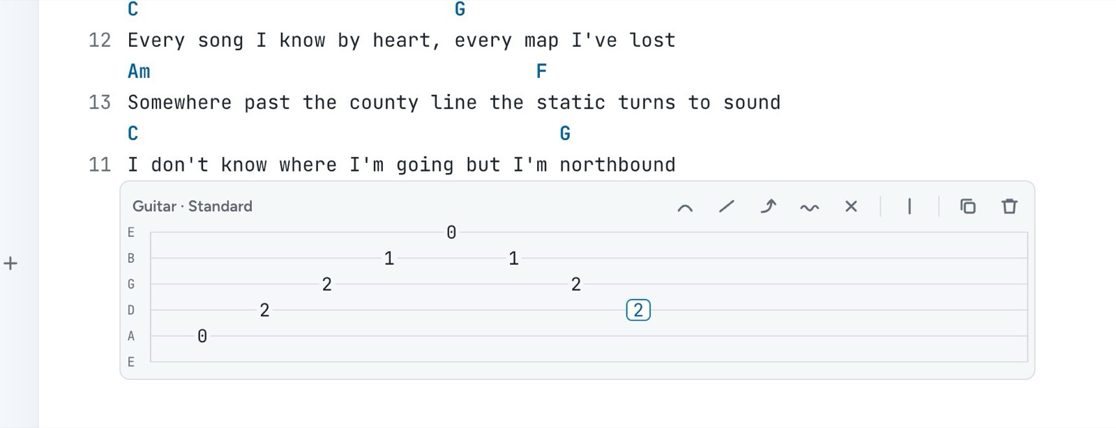 A tab block under a line of lyrics, with an A minor arpeggio and the toolbar for hammer-ons, slides, bends, vibrato, mutes, and bar lines